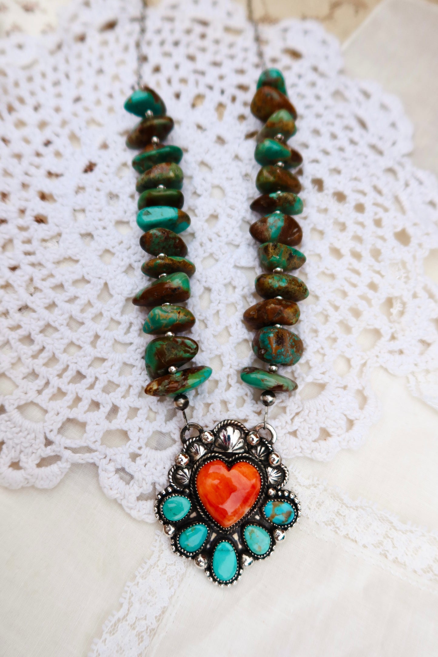 This striking pendant combines the vibrant blues and greens of Sonoran turquoise with the warm, iridescent hues of Spiny Oyster shell, all set in sterling silver. Genuine Mashan Chinese turquoise beads accent the design, adding depth and authentic character to this one-of-a-kind piece. This pendant makes a bold statement whether worn alone or layered with other pieces. A fun addition to any collection.