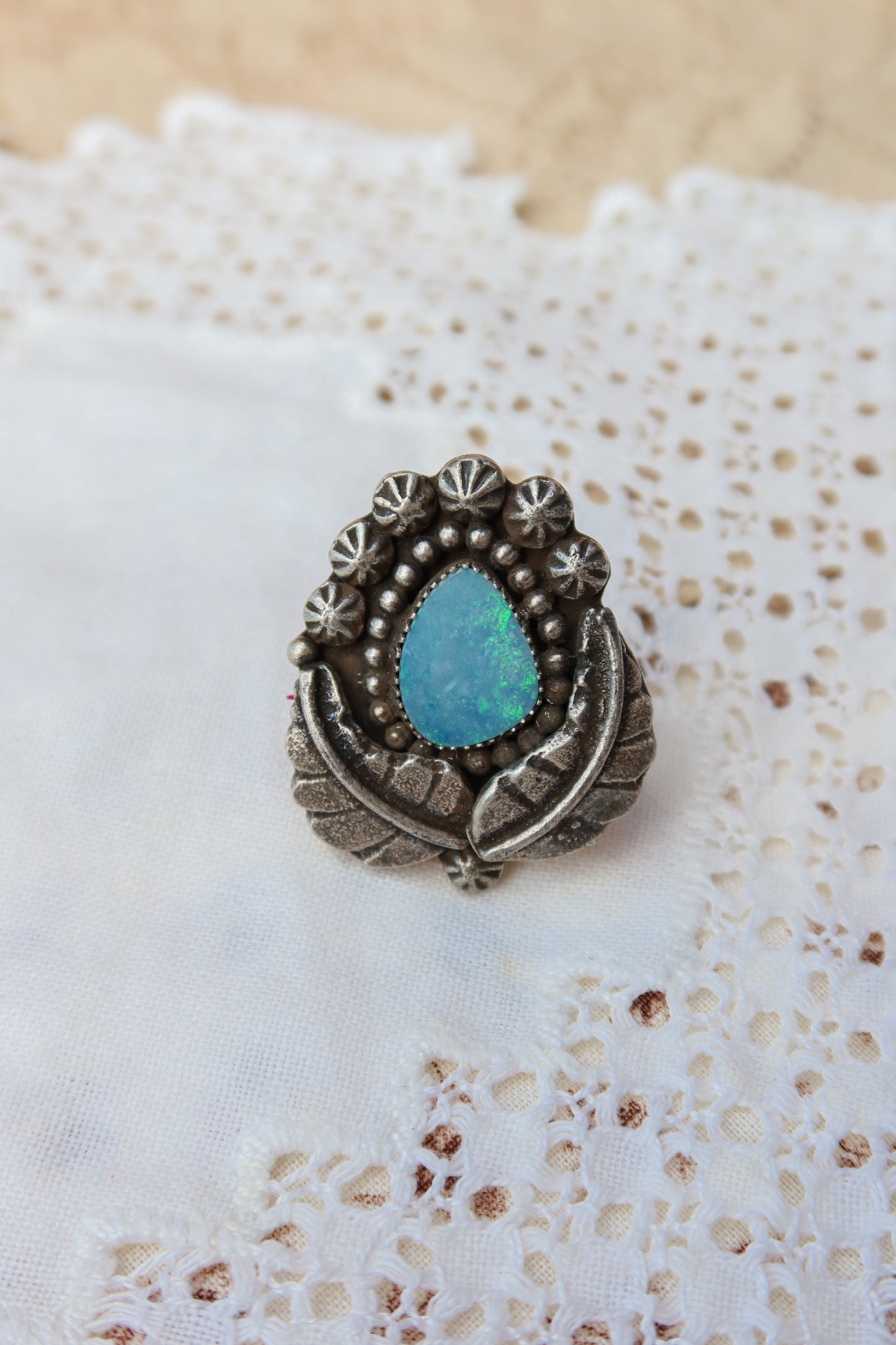 Sterling silver and genuine Australian opal ring size 8 1/2. Hand-crafted sand cast leaves frame a luminous opal center. Perfect for those who want a coastal southwestern feel!