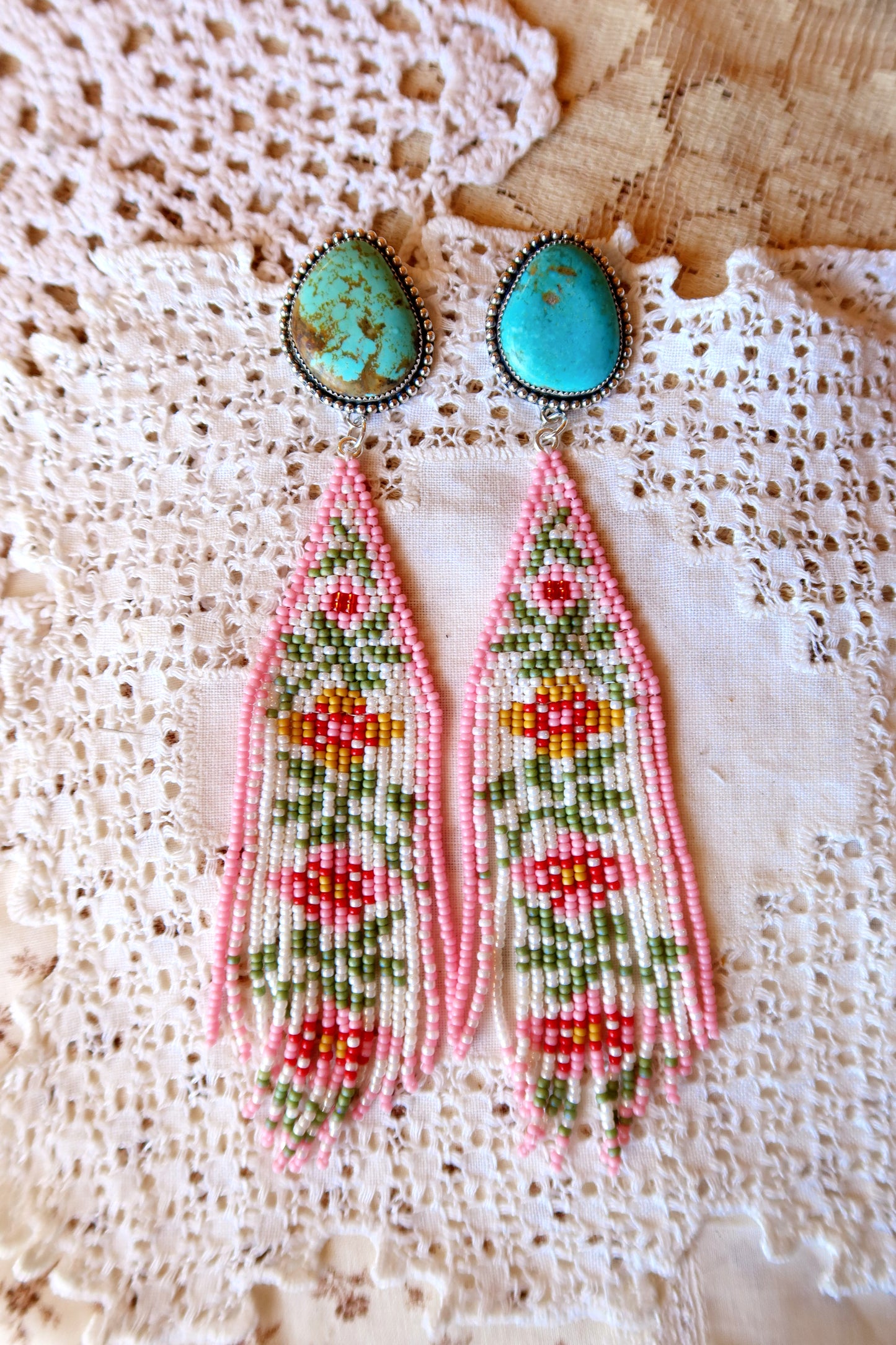 Bloom where you're beaded! These whimsical Sterling Silver and Turquoise Beaded Floral Earrings bring a touch of Southwestern charm to your everyday style. Each pair is meticulously hand-beaded with vibrant turquoise stones, creating delicate floral designs that dance with every movement. Handcrafted with love in South Texas, these earrings are a celebration of uniqueness and eccentric style. Perfect for adding a pop of color and personality to any outfit.