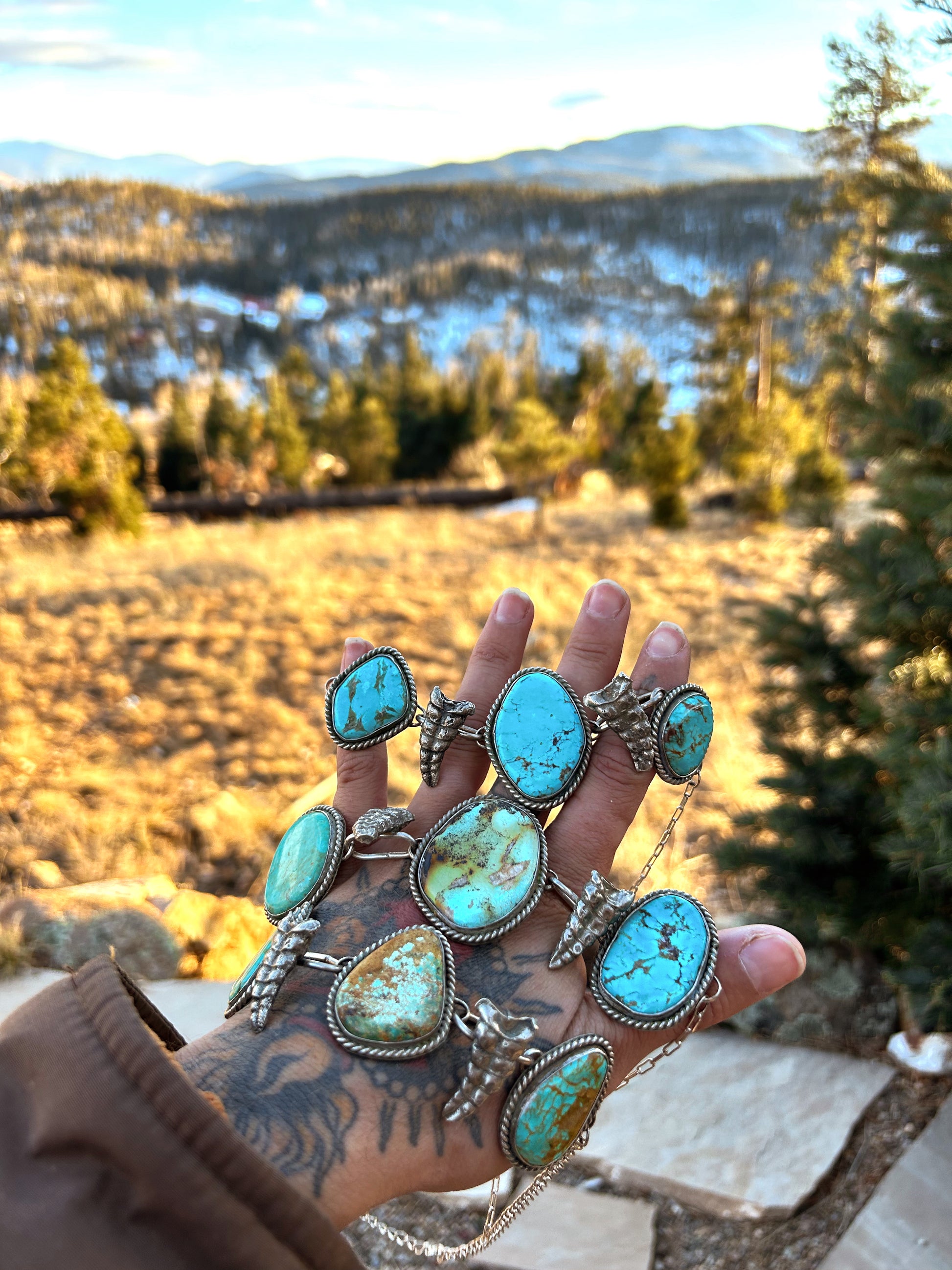 As seen on Ella Langley, elevate your style with this stunning Guera's Silver Original choker featuring genuine turquoise and Sterling Silver sand cast rattlesnake rattlers sourced directly from South Texas. Each piece showcases the natural beauty of premium turquoise varieties: Kingman, Sonoran, Alacran etc, and rosarita. Paired with sand cast rattlers for an unmistakable southwestern vibes. This is a preorder item and will take 6-7 weeks ETA.