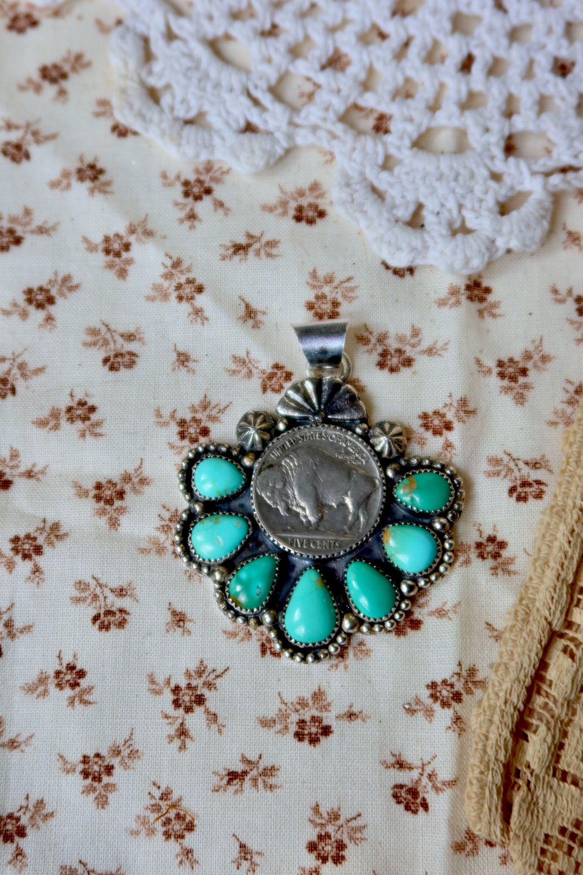 Wear a piece of magic around your neck! This Large pendant combines a vintage Buffalo Nickel with stunning Sonoran Turquoise, all crafted by hand right here in South Texas. Perfect for boho lovers, vintage collectors, and anyone who dreams of wide-open skies and desert sunsets. Let this handmade beauty tell your story.