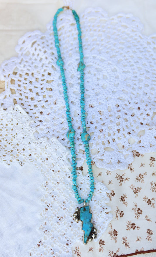 Hand-strung with Kingman turquoise beads, this fun necklace captures nature's electric spirit through a striking compressed solid Kingman turquoise lightning bolt pendant. A whimsical yet refined piece that brings celestial energy to any collection.