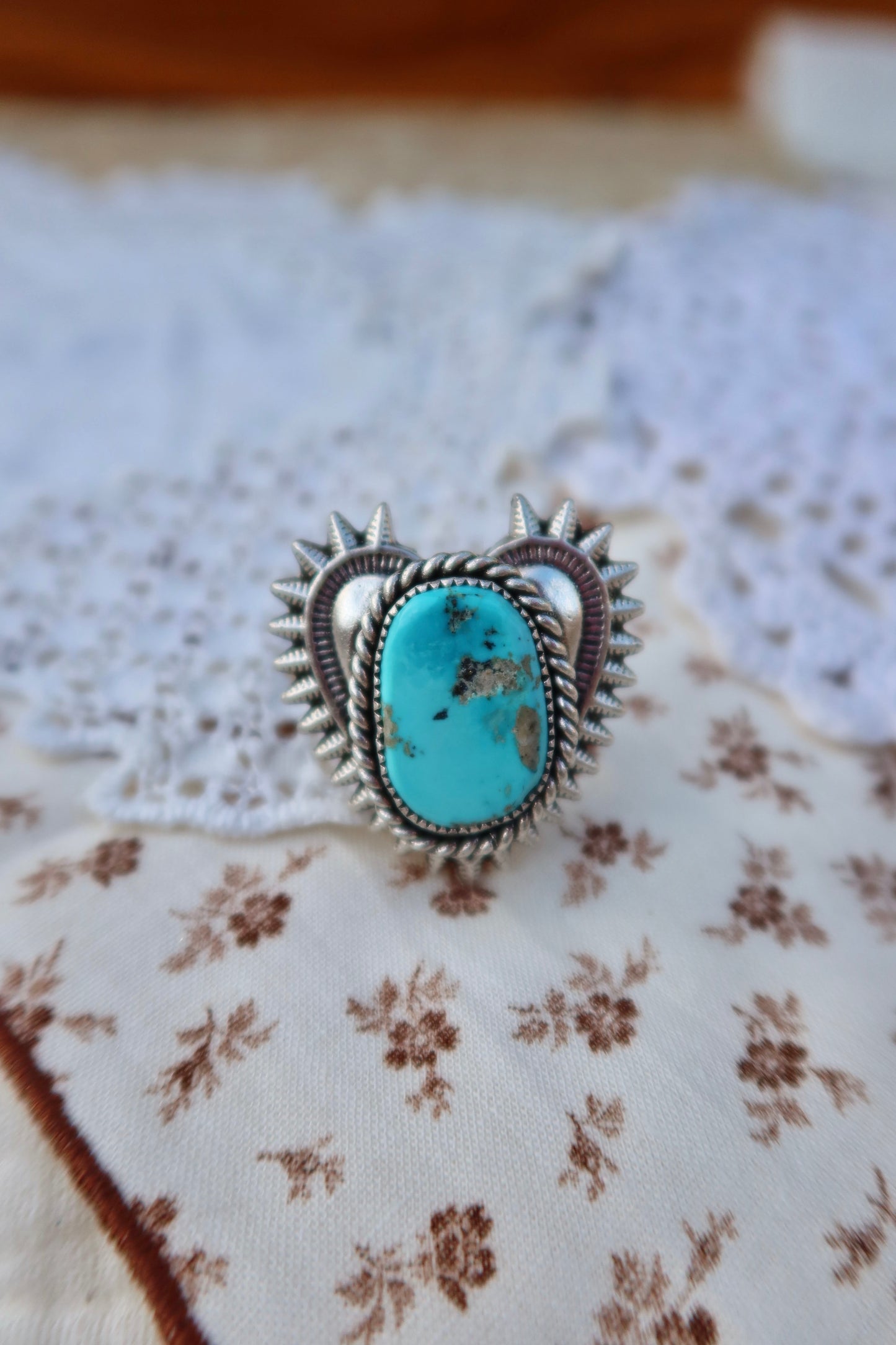 Handcrafted sterling silver heartbreaker ring featuring a striking blue gem turquoise stone set in a sand-cast design. This size 5 3/4 ring showcases the natural beauty of turquoise with its rich blue hues and organic texture, created using traditional sand casting techniques that give each piece a unique character. Perfect for everyday wear or special occasions.