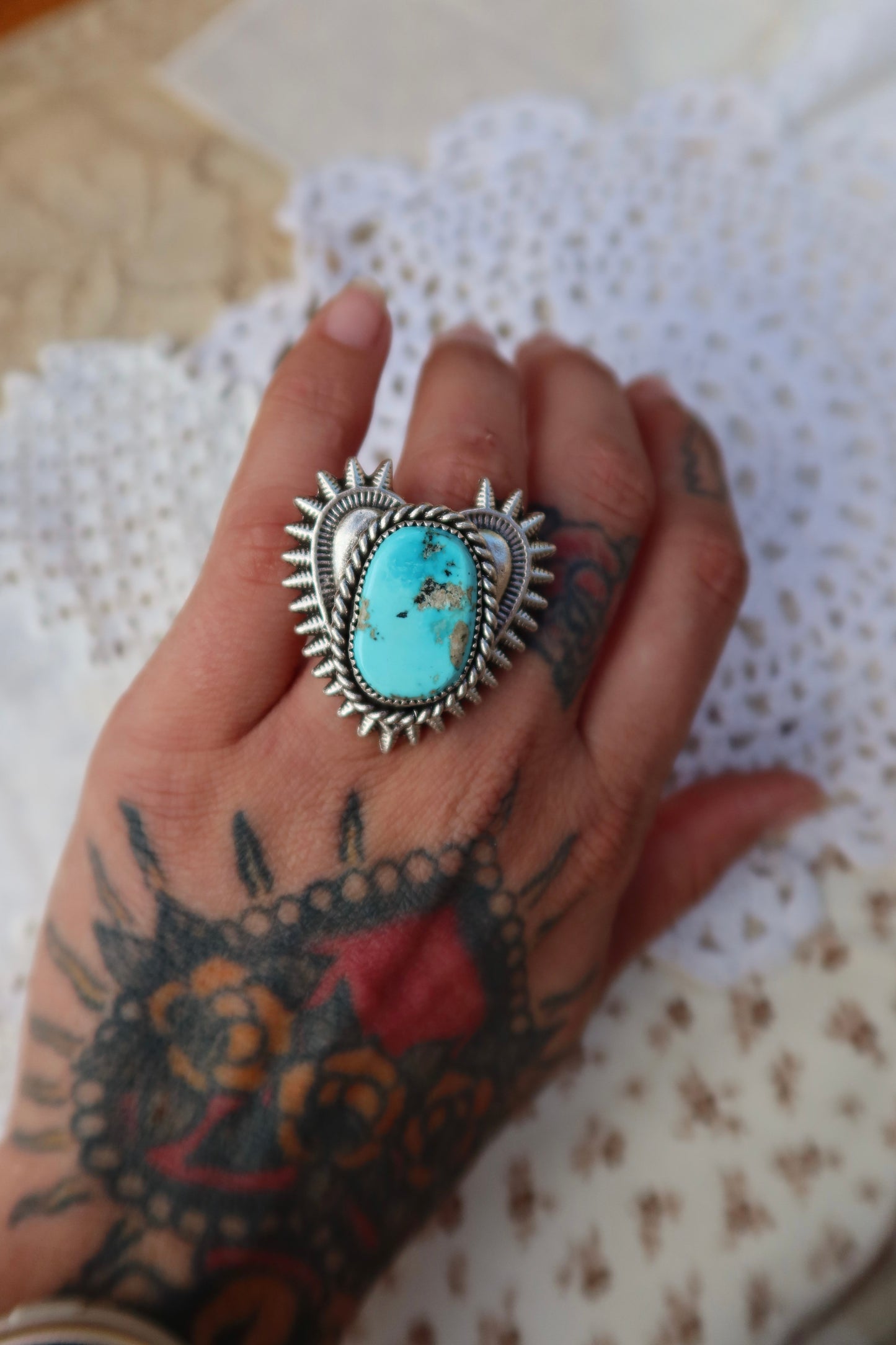 Handcrafted sterling silver heartbreaker ring featuring a striking blue gem turquoise stone set in a sand-cast design. This size 5 3/4 ring showcases the natural beauty of turquoise with its rich blue hues and organic texture, created using traditional sand casting techniques that give each piece a unique character. Perfect for everyday wear or special occasions.