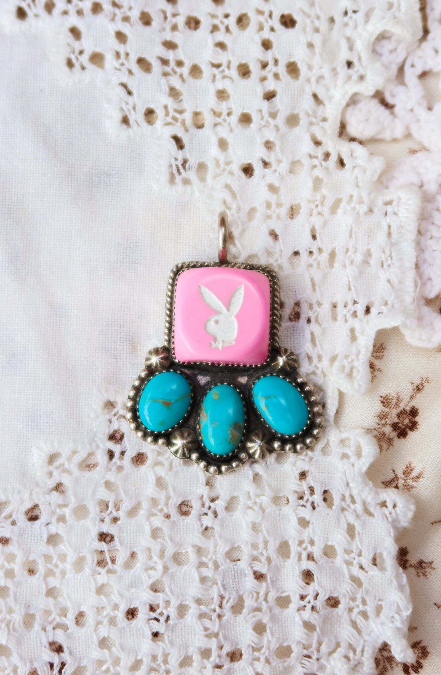 Fun Sterling Silver and Sonoran Turquoise Pink Playboy Pendant. Crafted with sterling silver, this piece features vibrant Sonoran turquoise with a pink playboy dice
