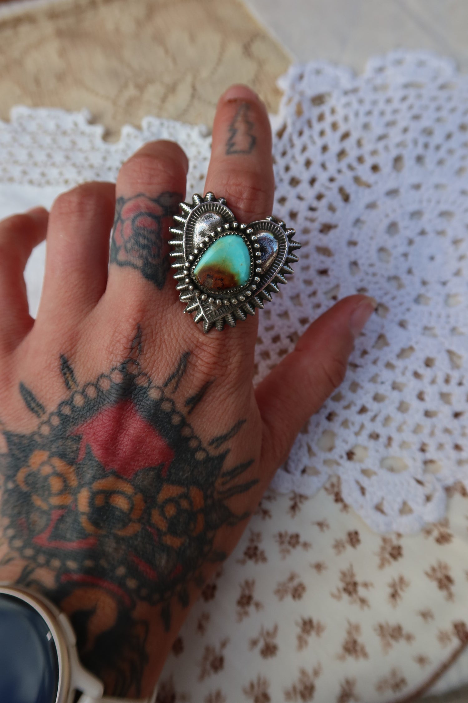 Handcrafted sterling silver heartbreaker ring featuring a striking Sonoran turquoise stone set in a sand-cast design. This size 10 ring showcases the natural beauty of turquoise with its rich blue hues and organic texture, created using traditional sand casting techniques that give each piece a unique character. Perfect for everyday wear or special occasions.