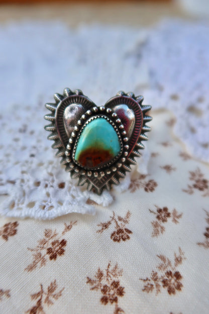 Handcrafted sterling silver heartbreaker ring featuring a striking Sonoran turquoise stone set in a sand-cast design. This size 10 ring showcases the natural beauty of turquoise with its rich blue hues and organic texture, created using traditional sand casting techniques that give each piece a unique character. Perfect for everyday wear or special occasions.