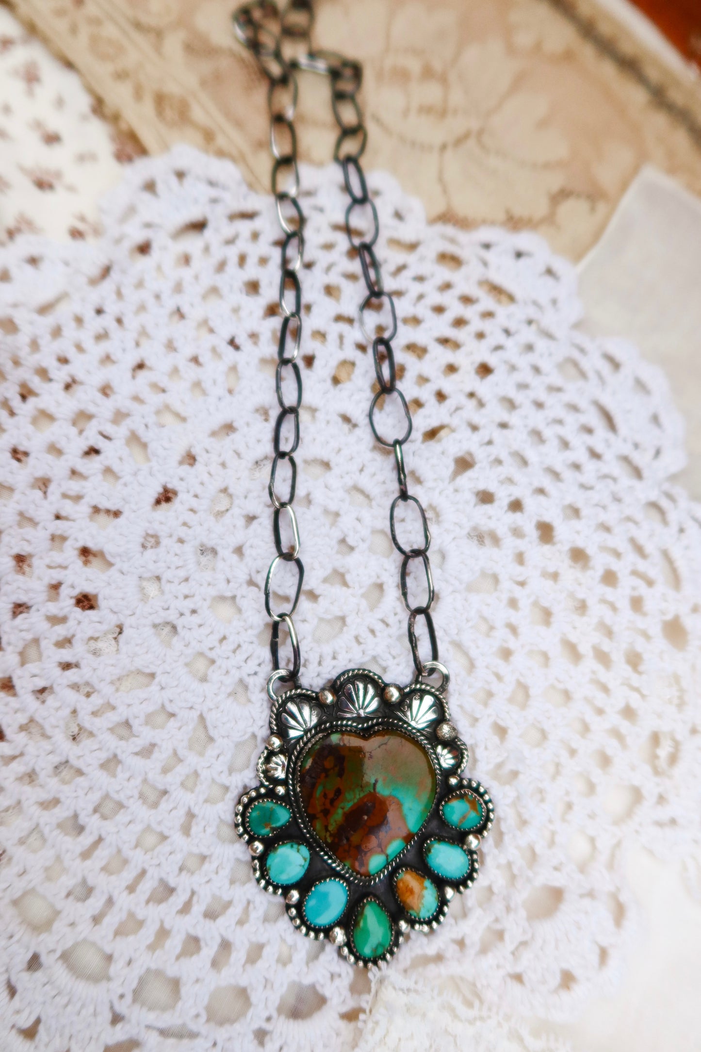 Sterling silver heart pendant, featuring a striking combination of Hubei and Sonoran turquoise stones. Paired with a handmade sterling silver paperclip chain and hand stamped ornaments, it's perfect for layering or wearing solo.