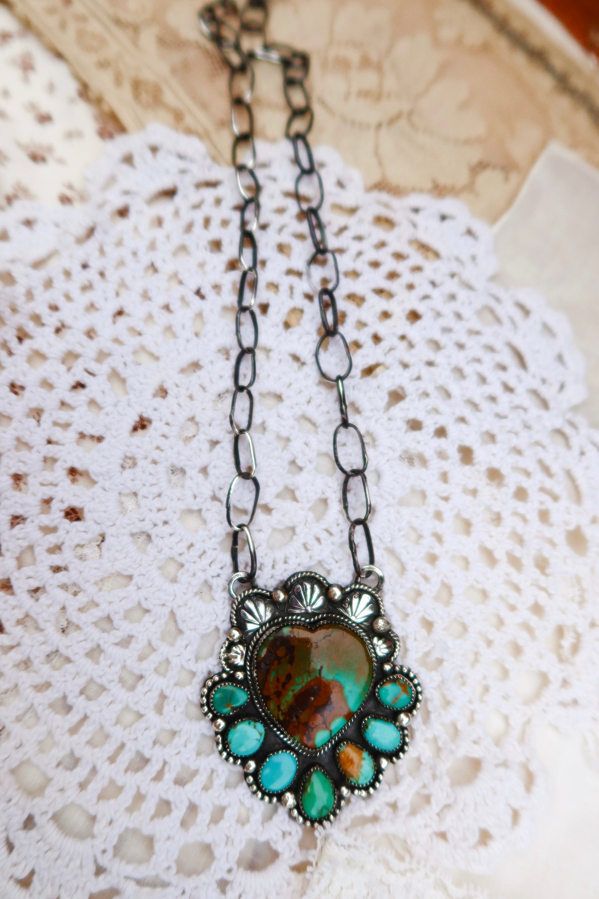 Sterling silver heart pendant, featuring a striking combination of Hubei and Sonoran turquoise stones. Paired with a handmade sterling silver paperclip chain and hand stamped ornaments, it's perfect for layering or wearing solo.