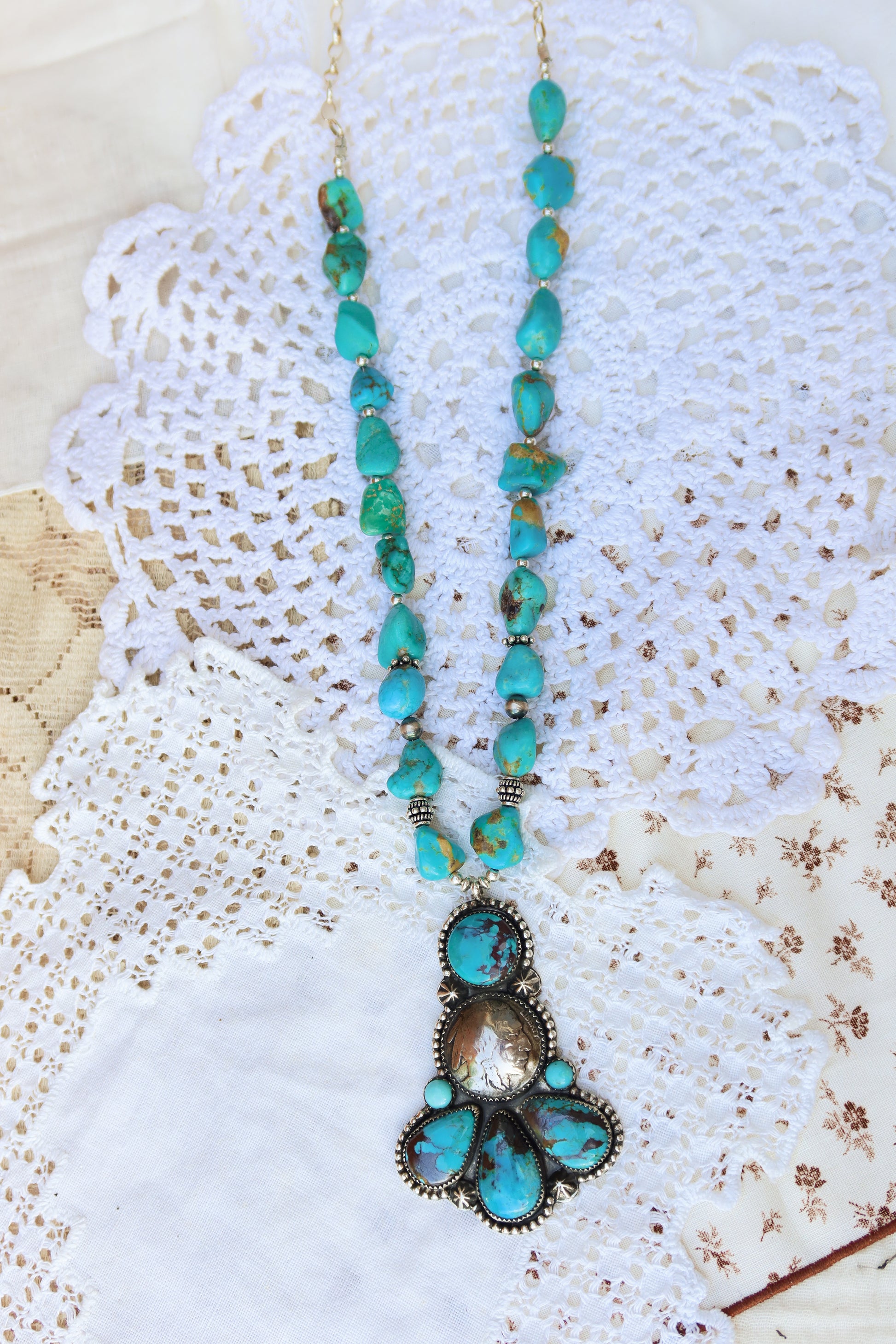Enchanting Kingman turquoise beaded necklace strung with gleaming sterling silver machine-made beads, each one catches the light like a tiny desert star. Kingman Turquoise stones with a shiny Buffalo nickel at the center. This necklace is perfect for any occasion!