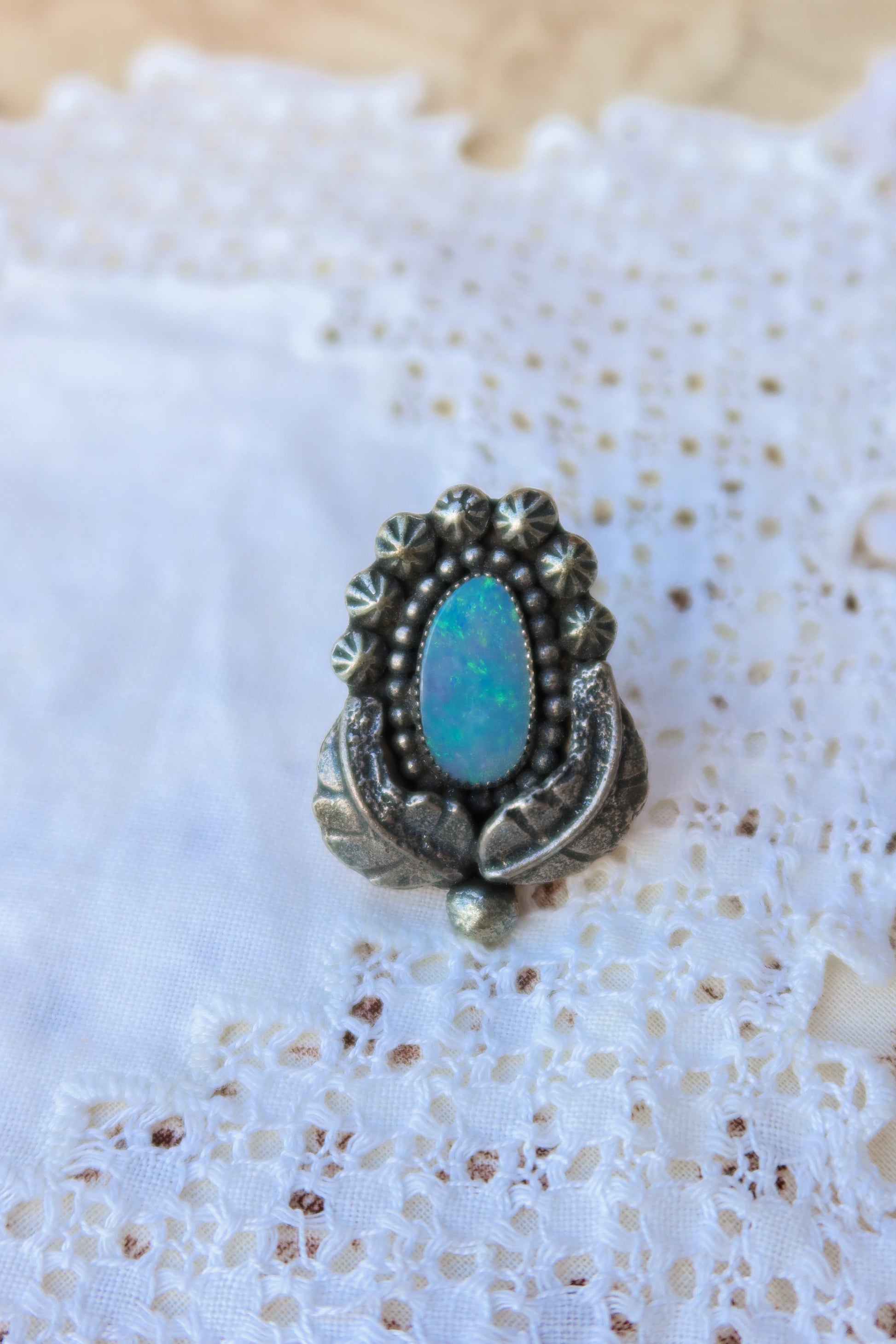 Sterling silver and genuine Australian opal ring size 6. Hand-crafted sand cast leaves frame a luminous opal center. Perfect for those who want a coastal southwestern feel!