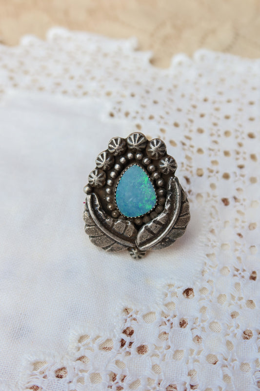 Sterling silver and genuine Australian opal ring size 8 1/2. Hand-crafted sand cast leaves frame a luminous opal center. Perfect for those who want a coastal southwestern feel!
