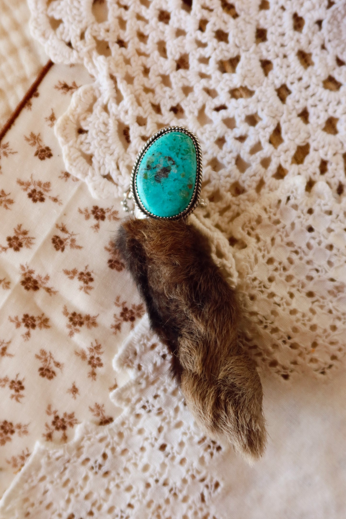 Carry a touch of enchantment with this whimsical Sterling Silver and Turquoise Rabbits foot Keychain, lovingly handcrafted in South Texas. Let this magical little charm dance from your keys, dangle from your purse, or nestle close to your heart as a pendant. A sprinkle of south Texas charm wherever you wander.