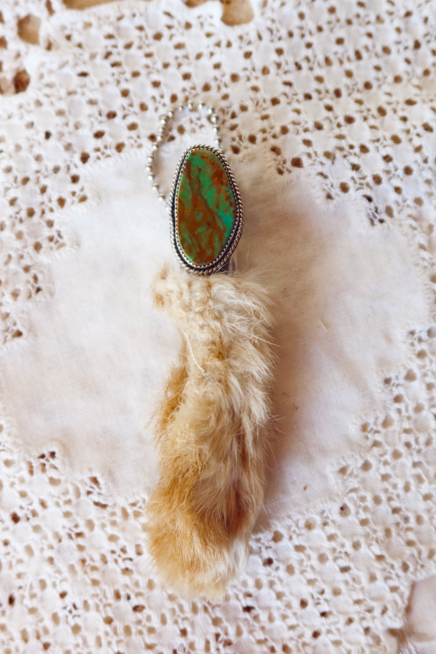 Carry a touch of enchantment with this whimsical Sterling Silver and Turquoise Rabbits foot Keychain, lovingly handcrafted in South Texas. Let this magical little charm dance from your keys, dangle from your purse, or nestle close to your heart as a pendant. A sprinkle of south Texas charm wherever you wander.