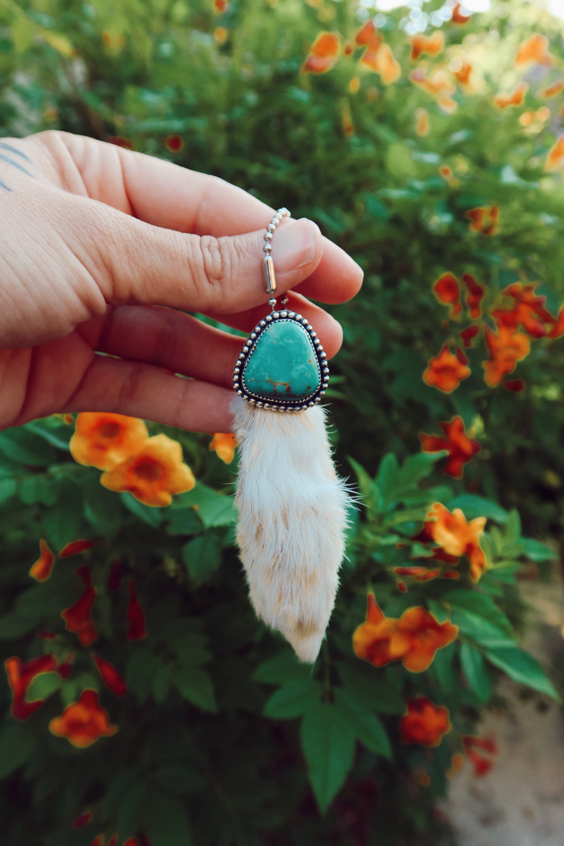 Carry a touch of enchantment with this whimsical Sterling Silver and Turquoise Rabbits foot Keychain, lovingly handcrafted in South Texas. Let this magical little charm dance from your keys, dangle from your purse, or nestle close to your heart as a pendant. A sprinkle of south Texas charm wherever you wander.