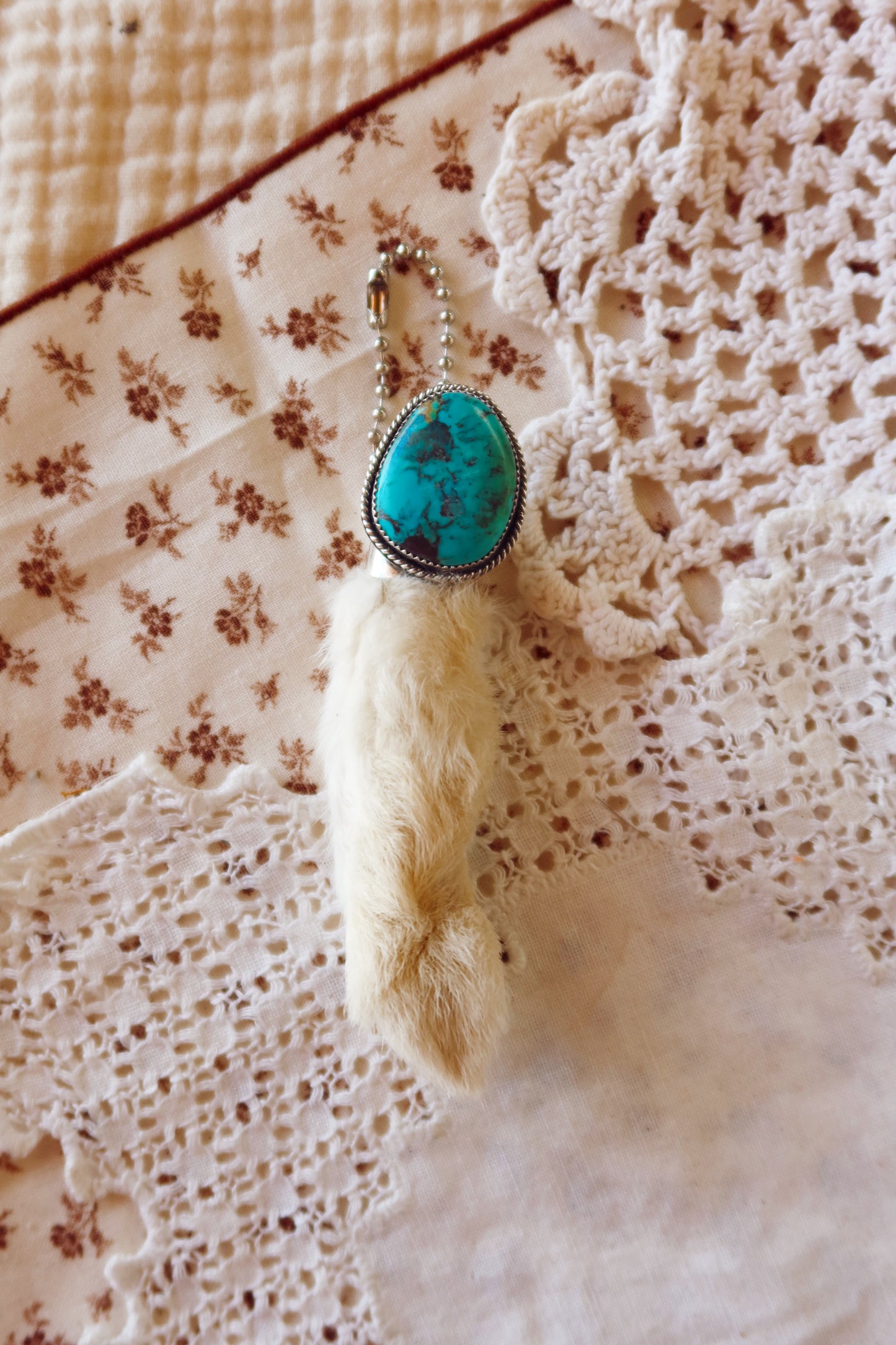 Carry a touch of enchantment with this whimsical Sterling Silver and Turquoise Rabbits foot Keychain, lovingly handcrafted in South Texas. Let this magical little charm dance from your keys, dangle from your purse, or nestle close to your heart as a pendant. A sprinkle of south Texas charm wherever you wander.