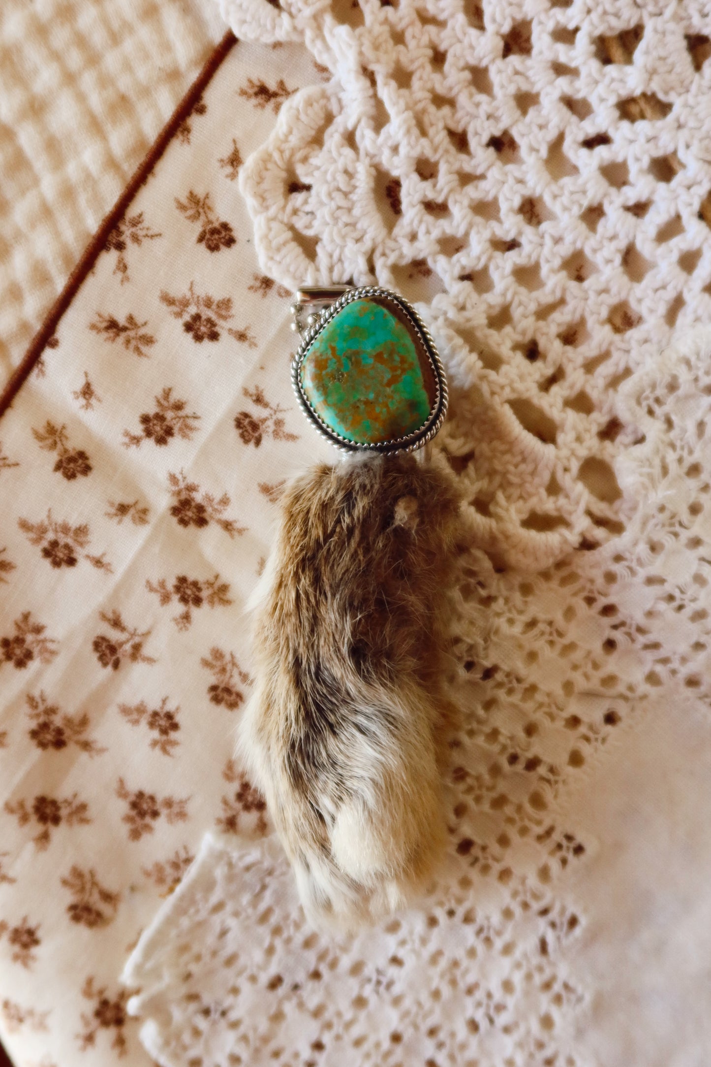 Carry a touch of enchantment with this whimsical Sterling Silver and Turquoise Rabbits foot Keychain, lovingly handcrafted in South Texas. Let this magical little charm dance from your keys, dangle from your purse, or nestle close to your heart as a pendant. A sprinkle of south Texas charm wherever you wander.