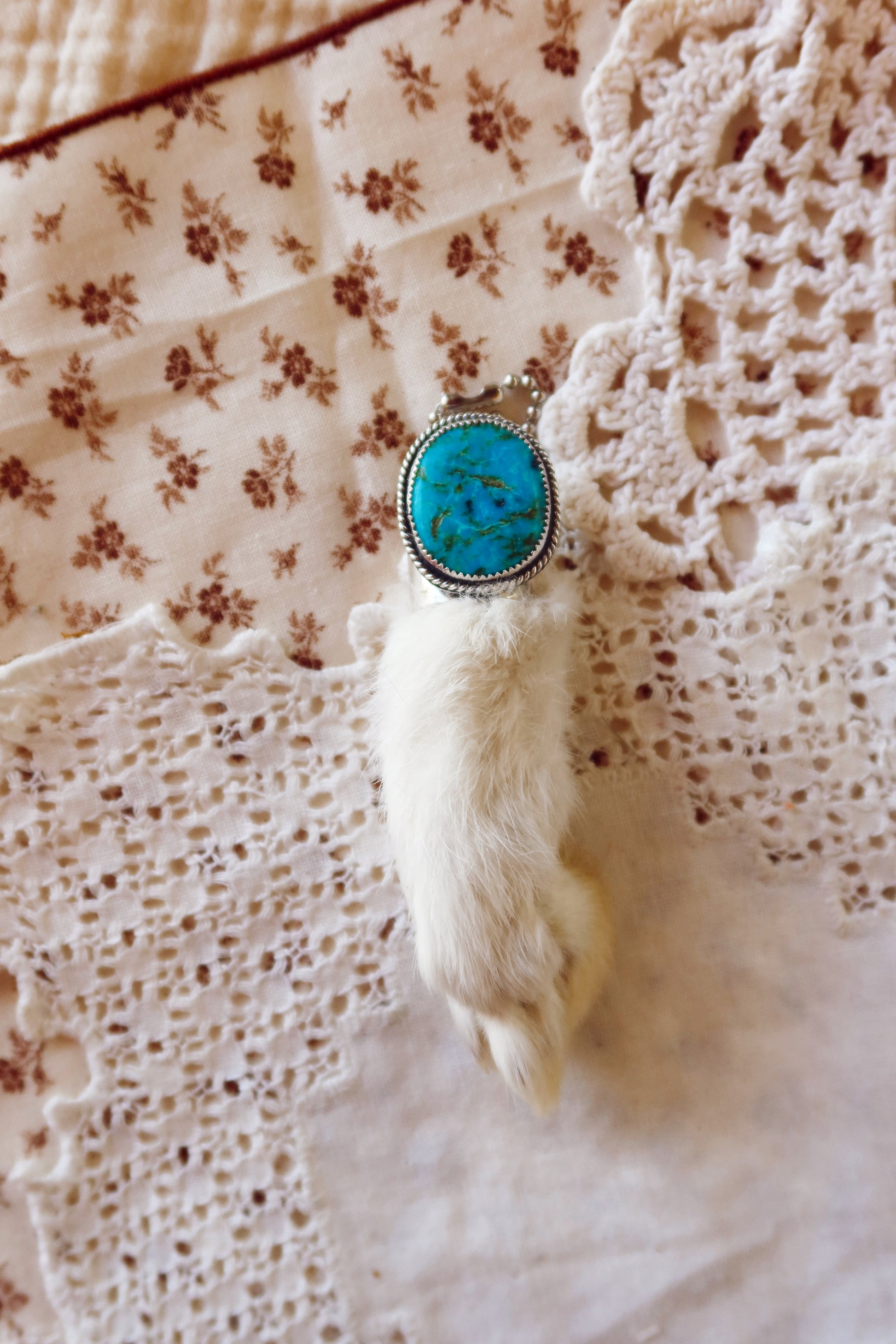 Carry a touch of enchantment with this whimsical Sterling Silver and Turquoise Rabbits foot Keychain, lovingly handcrafted in South Texas. Let this magical little charm dance from your keys, dangle from your purse, or nestle close to your heart as a pendant. A sprinkle of south Texas charm wherever you wander.