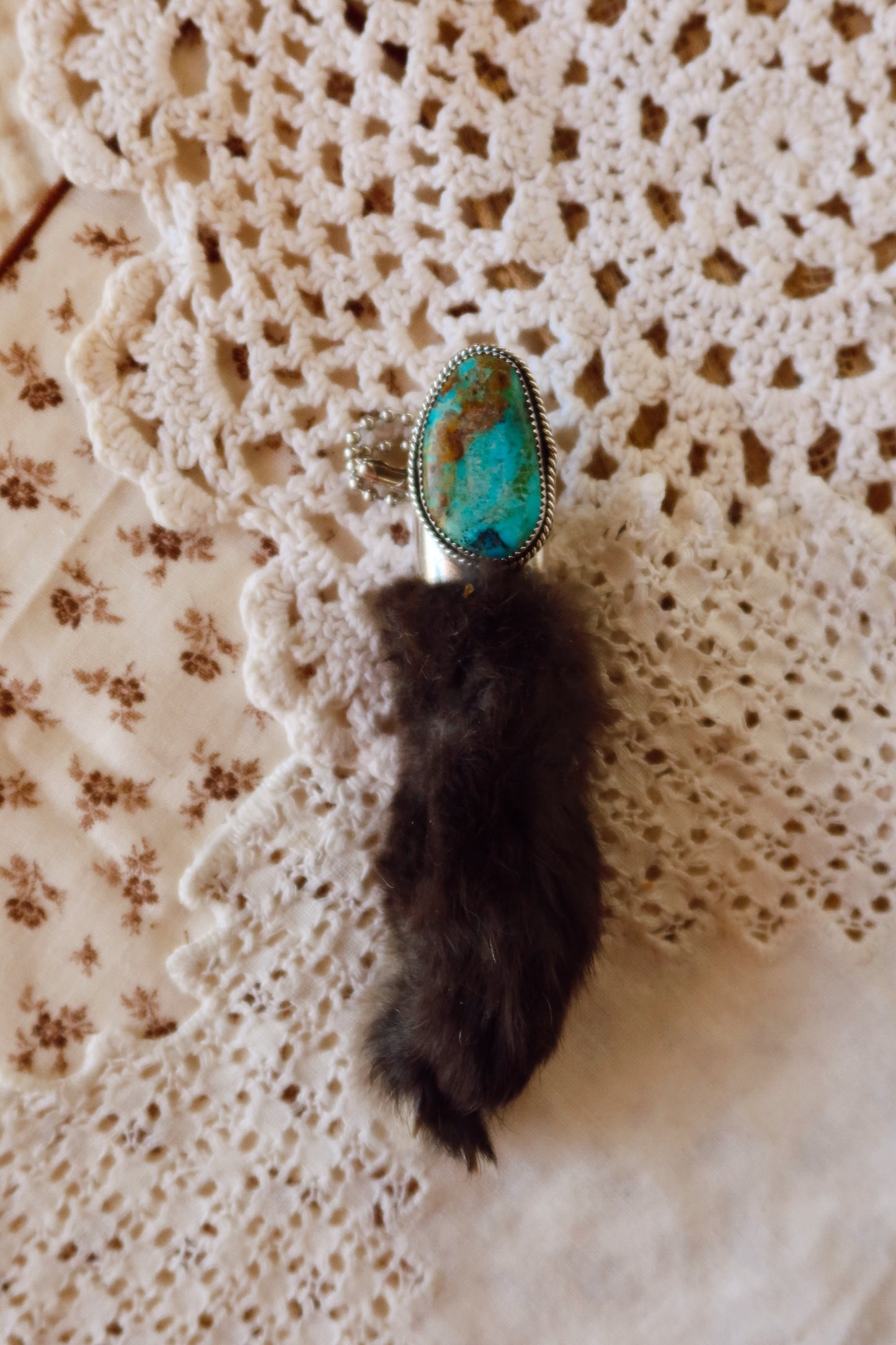 Carry a touch of enchantment with this whimsical Sterling Silver and Turquoise Rabbits foot Keychain, lovingly handcrafted in South Texas. Let this magical little charm dance from your keys, dangle from your purse, or nestle close to your heart as a pendant. A sprinkle of south Texas charm wherever you wander.
