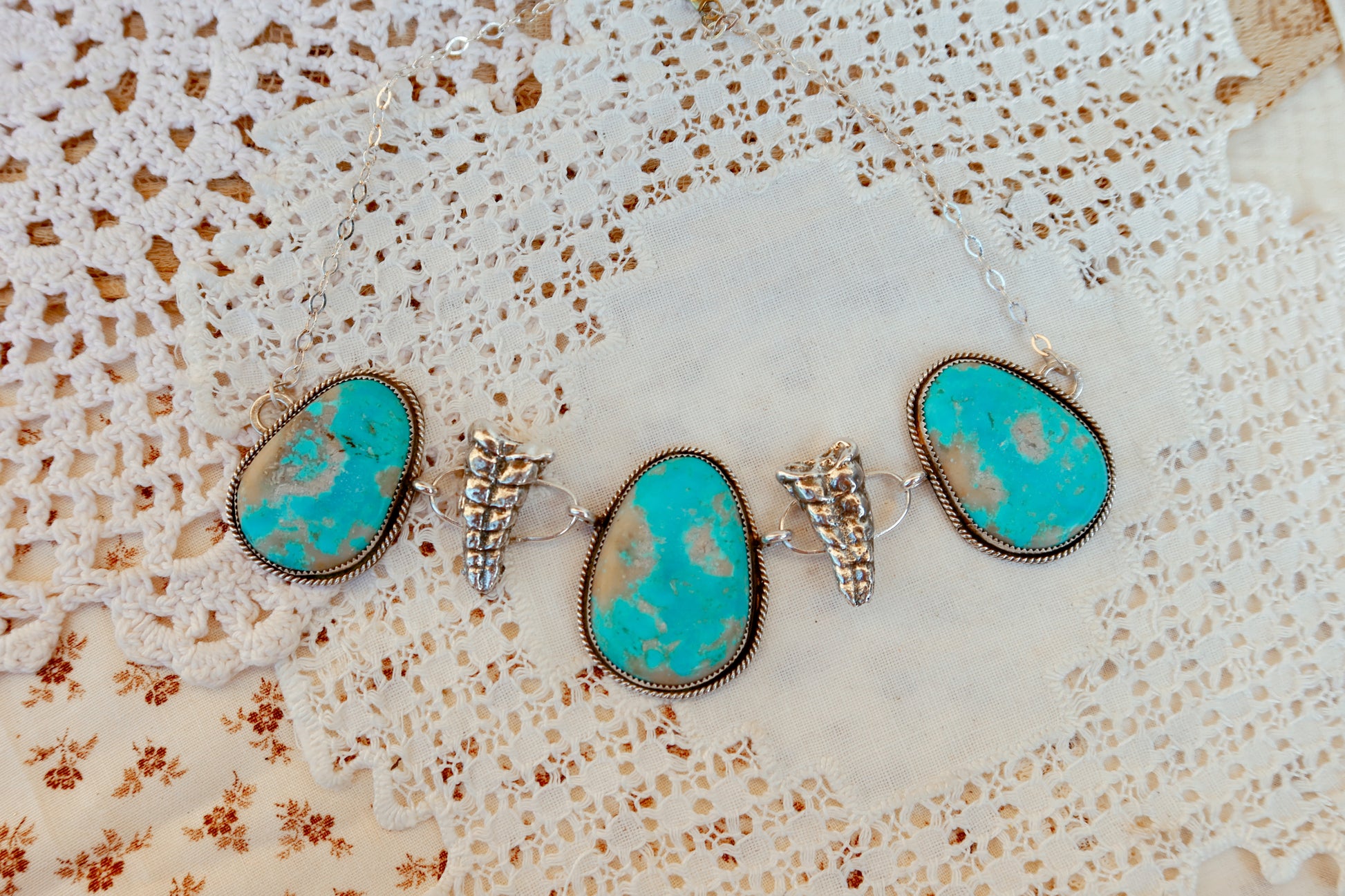 As seen on Ella Langley, shake things up with this whimsical Kingman Turquoise Sterling Silver Rattler choker—a bold statement piece that's equal parts charm and character. Handcrafted right here in South Texas, this beauty features stunning Kingman turquoise paired with sterling silver Rattlesnake rattlers sourced from South Texas. Whether you're channeling your inner whimsy or just love jewelry with personality, this rattler choker is the perfect conversation starter. Wear it proud and let your style shin