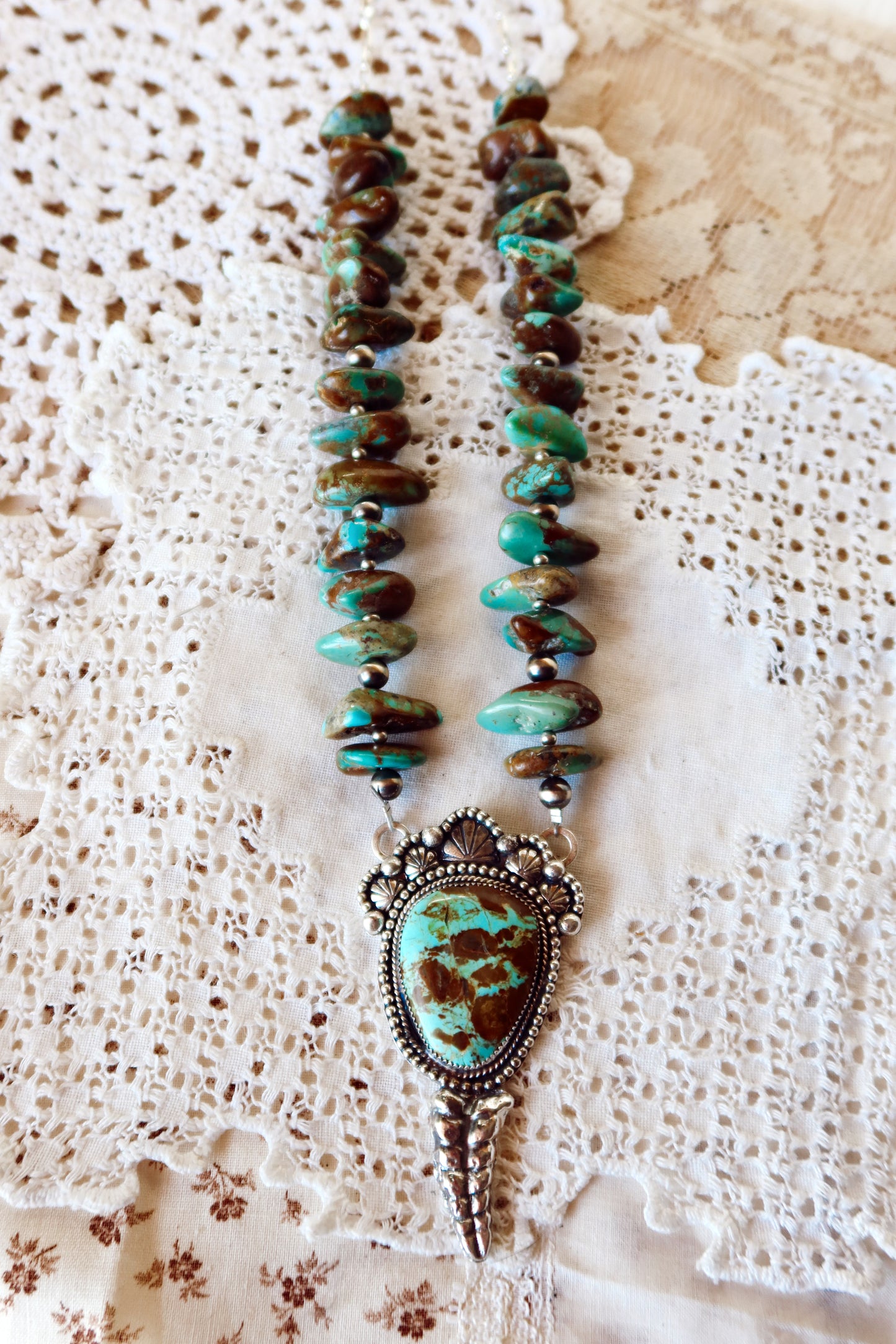 Shake things up with this whimsical LARGE Kingman Turquoise Sterling Silver Rattler Pendant—a bold statement piece that's equal parts charm and character. Handcrafted right here in South Texas, this beauty features stunning Kingman turquoise paired with delicate Chinese turquoise beads and sterling silver accents that catch the light beautifully. Whether you're channeling your inner whimsy or just love jewelry with personality, this rattler pendant is the perfect conversation starter. Wear it proud and let 