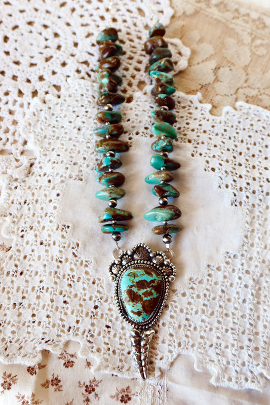 Shake things up with this whimsical LARGE Kingman Turquoise Sterling Silver Rattler Pendant—a bold statement piece that's equal parts charm and character. Handcrafted right here in South Texas, this beauty features stunning Kingman turquoise paired with delicate Chinese turquoise beads and sterling silver accents that catch the light beautifully. Whether you're channeling your inner whimsy or just love jewelry with personality, this rattler pendant is the perfect conversation starter. Wear it proud and let 