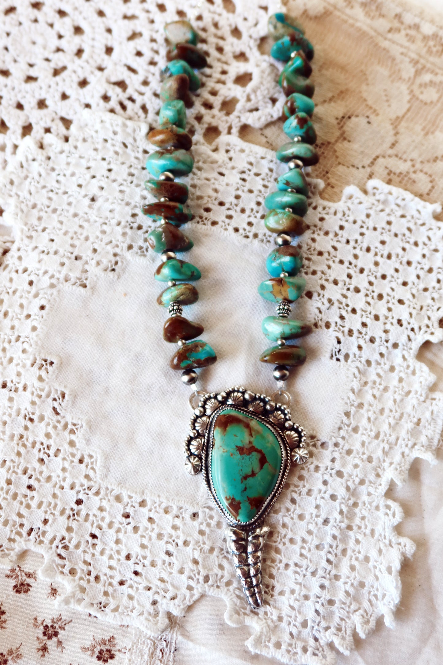 Shake things up with this whimsical LARGE Kingman Turquoise Sterling Silver Rattler Pendant—a bold statement piece that's equal parts charm and character. Handcrafted right here in South Texas, this beauty features stunning Kingman turquoise paired with delicate Chinese turquoise beads and sterling silver accents that catch the light beautifully. Whether you're channeling your inner whimsy or just love jewelry with personality, this rattler pendant is the perfect conversation starter. Wear it proud and let 