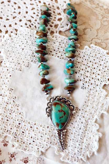 Shake things up with this whimsical LARGE Kingman Turquoise Sterling Silver Rattler Pendant—a bold statement piece that's equal parts charm and character. Handcrafted right here in South Texas, this beauty features stunning Kingman turquoise paired with delicate Chinese turquoise beads and sterling silver accents that catch the light beautifully. Whether you're channeling your inner whimsy or just love jewelry with personality, this rattler pendant is the perfect conversation starter. Wear it proud and let 