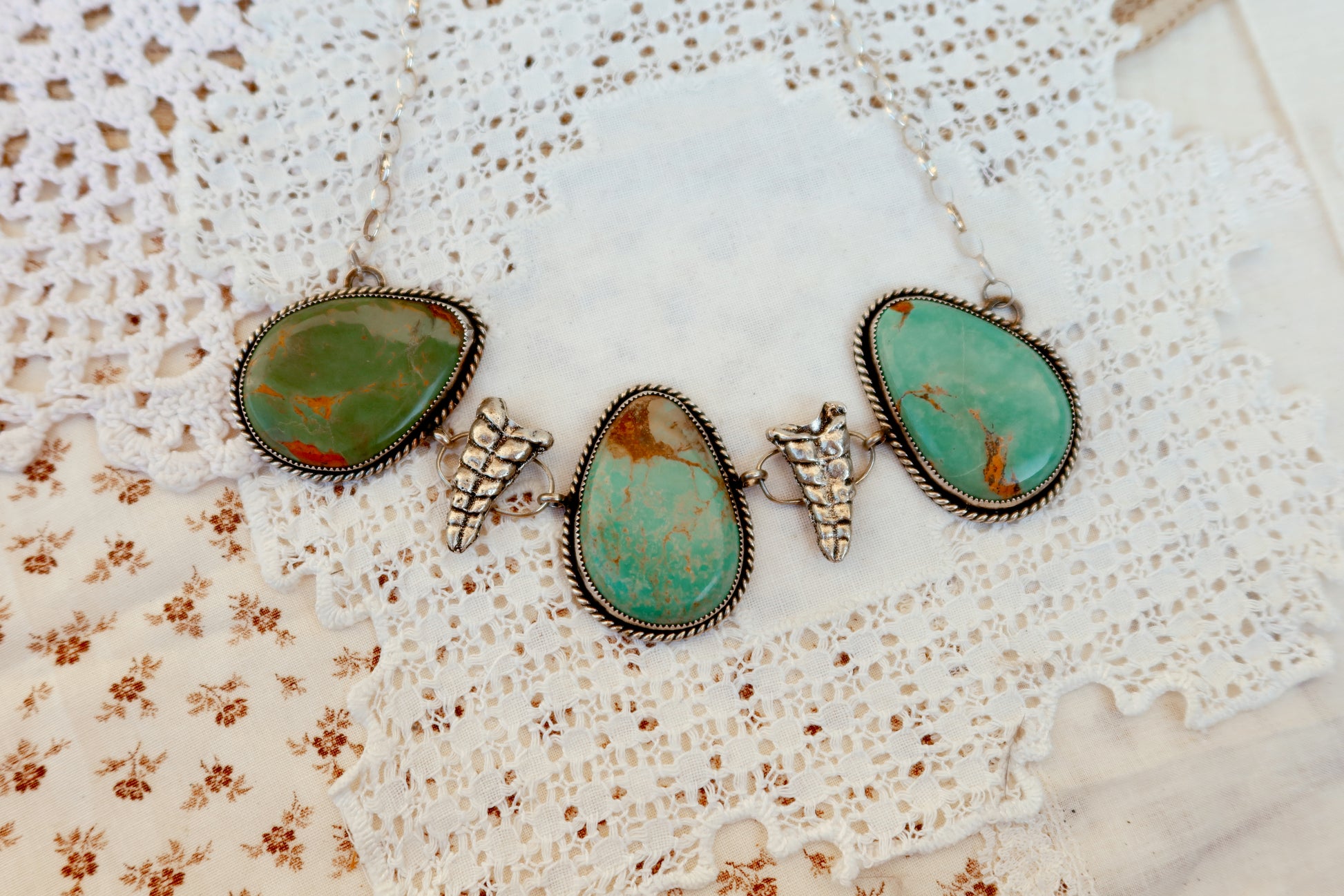 As seen on Ella Langley, shake things up with this whimsical Kingman Turquoise Sterling Silver Rattler choker—a bold statement piece that's equal parts charm and character. Handcrafted right here in South Texas, this beauty features stunning Kingman turquoise paired with sterling silver Rattlesnake rattlers sourced from South Texas. Whether you're channeling your inner whimsy or just love jewelry with personality, this rattler choker is the perfect conversation starter. Wear it proud and let your style shin