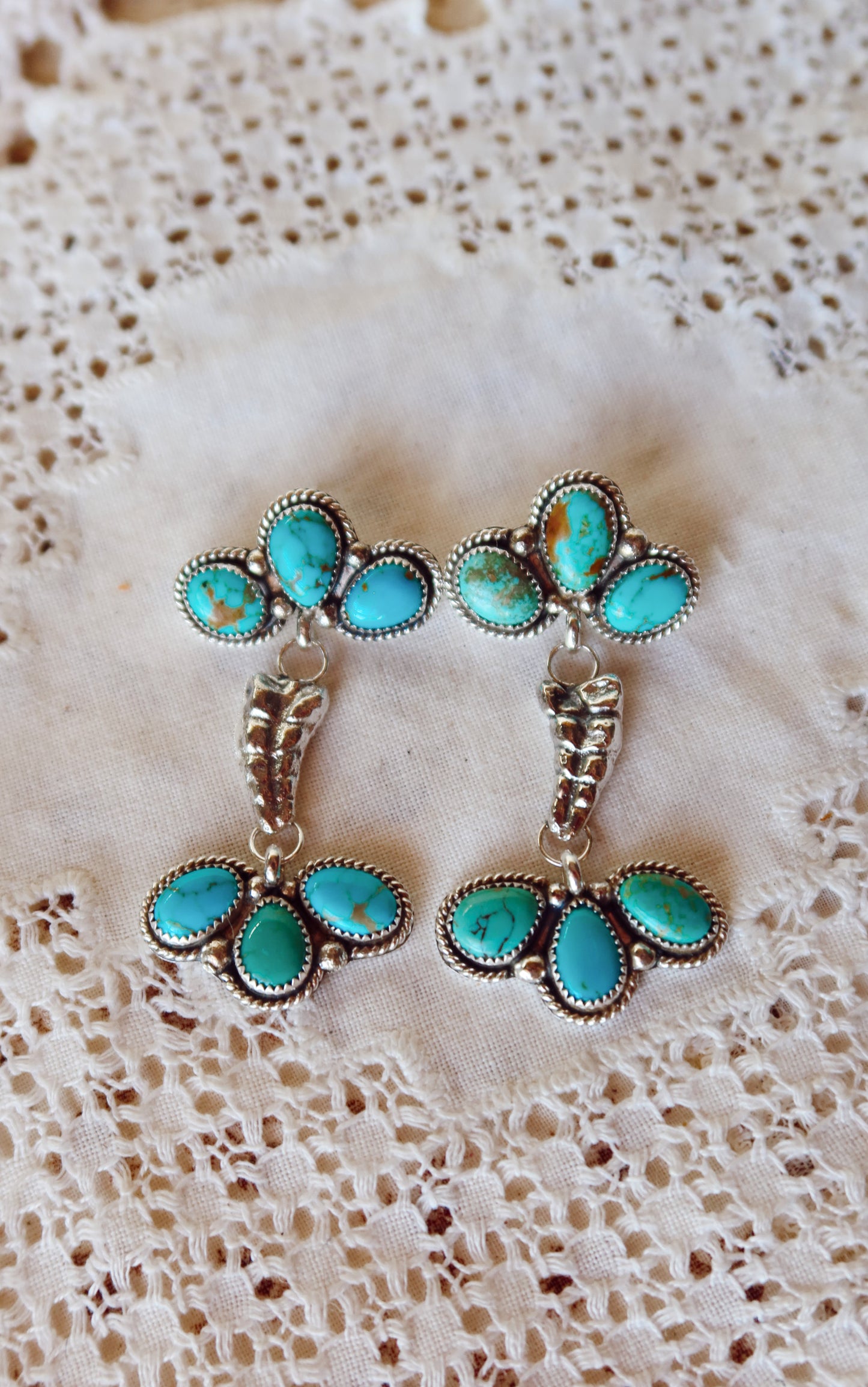 Elevate your style with these whimsical Sterling Silver and Sonoran Turquoise Mix Rattler Earrings—handcrafted right here in South Texas! Each pair features vibrant turquoise stones paired with gleaming sterling silver, creating a unique piece that dances with every move. Perfect for those who love a little personality in their jewelry. Wear them and let your ears do the talking!